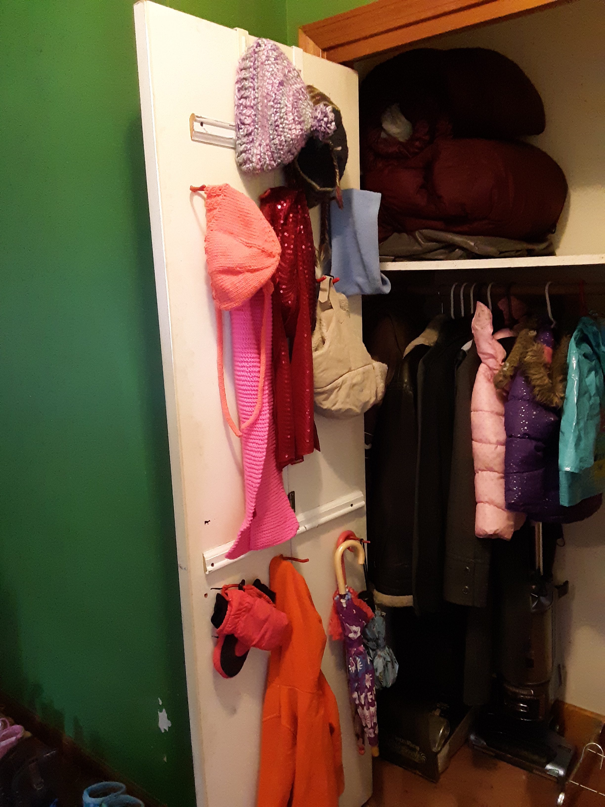 We hung hooks to organize hats, scarves, mittens, and umbrellas