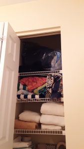 Shelves with towels and sheets before better folding