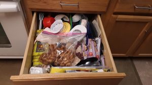 The kitchen gadgets and snacks drawer before we cleared its clutter.