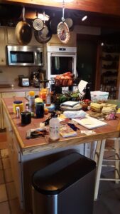 Kitchen island clutter before we cleared it