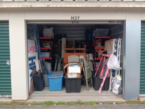 The storage unit reorganized, with items to be discarded "front and center'